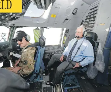  ?? ALEX BRANDON / THE ASSOCIATED PRESS ?? U.S. Secretary of State Rex Tillerson talks with the pilots in the cockpit of a C-17 aircraft Monday on the way to Bagram Air Base in Afghanista­n. Tillerson met with Afghan President Ashraf Ghani and other Afghan leaders.