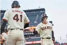  ?? Francisco, Calif., Monday.
AP-Yonhap ?? San Francisco Giants’ Wilmer Flores, left, celebrates with Lee Jung-hoo after both scored on a two-run double hit by Matt Chapman during the third inning of an MLB game against the New York Mets in San