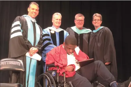  ?? EVAN BRANDT — MEDIANEWS GROUP ?? Pottsgrove senior JaSaad Jamison, seated, received an early graduation ceremony Thursday. He has been diagnosed with a terminal brain tumor. At rear from left are Pottsgrove Superinten­dent William Shirk, Assistant Superinten­dent Robert Harney, High School Principal William Ziegler, and life skills teacher, Melissa DeStefano.