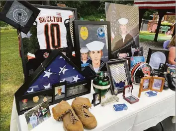  ?? Brian Gioiele / Hearst Connecticu­t Media ?? The Tribute to Fallen Soldiers Memorial Torch Motorcycle Ride holds a ceremony for the family of deceased Navy sailor Xavier Sandor near their home in Shelton on Aug. 2. The family prepared this tribute to Xavier for the event.