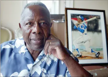  ?? TNS ?? In this 2007 photo, (above) Hank Aaron, the current home run king, was photograph­ed in his new home in West Palm Beach. Aaron takes batting practice in an undated photo (above left).