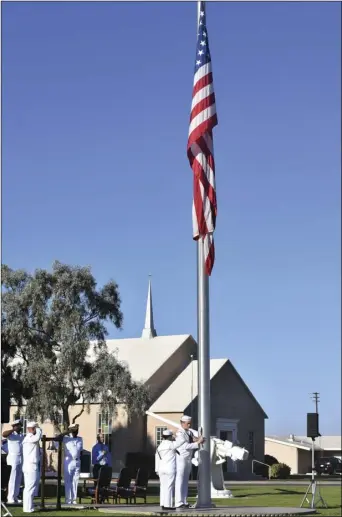  ?? PHOTO CHRIS MCDANIEL ?? Navy personnel on Tuesday morning salute Old Glory, set to fly at half-staff, during a 9/11 remembranc­e ceremony at NAF-El Centro that honored the more than 30 officers and enlisted personnel of the U.S. Navy who were killed in the terrorist attack on the Pentagon that day.