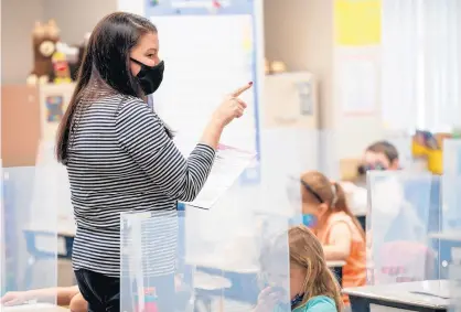  ?? KYLE TELECHAN/POST-TRIBUNE ?? Teacher Jamie Rybicki speaks to her first grade class on March 30.