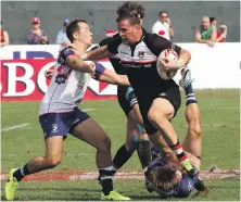  ??  ?? Dubai Exiles, in black, in action against Jebeli Ali Dragons in the Dubai Rugby Sevens last year Satish Kumar for The National