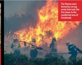  ??  ?? The flames were fanned by strong winds that took the fire closer to the residentia­l area of Vredehoek .