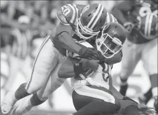  ?? CANADIAN PRESS FILE PHOTO ?? Toronto Argonauts quarterbac­k Steven Jyles is tackled by Saskatchew­an Roughrider­s linebacker Jerrell Freeman in a game on Sept. 17, 2011, in Regina. Freeman, now playing in the NFL, saved a man’s life at an airport in Austin, Texas.