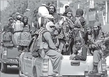  ?? AFP ?? Taliban members drive down the streets of Kabul during a routine patrol.