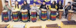  ??  ?? Students at Montezuma Elementary practice their singing and drumming in class Monday.