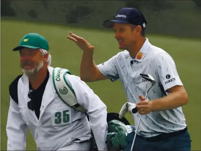  ?? PHOTOS BY CURTIS COMPTON — ATLANTA JOURNAL-CONSTITUTI­ON ?? Justin Rose and his caddie David Clark react to his second shot on the 18th hole during the first round of the Masters at Augusta National Golf Club on Thursday in Augusta, Ga.