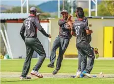  ?? Courtesy: ICC ?? UAE players celebrate a Oman wicket during the ICC World Cricket League (Division two) at Windhoek on Monday.