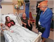  ?? Peter Byrne / Pool photo via Associated Press ?? Britain’s Queen Elizabeth II, right, speaks to Millie Robson, 15, and her mother Marie as she visits the Royal Manchester Children’s Hospital.