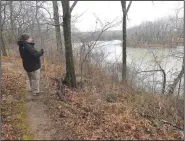  ?? (NWA Democrat-Gazette/Flip Putthoff) ?? Views of Lake Sequoyah are part of the scenery along the Rookery Trail. Mike McBride takes in a vista at the start of the path.