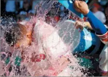  ?? LAURENCE KESTERSON — THE ASSOCIATED PRESS ?? Philadelph­ia Phillies’ Aaron Altherr, left, is doused after hitting an RBI walkoff single in the 11th inning of a baseball game against the Pittsburgh Pirates, Sunday in Philadelph­ia.