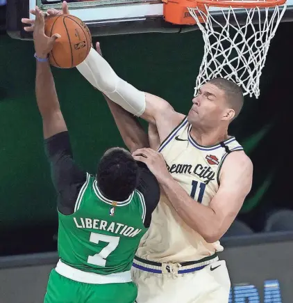  ?? ASSOCIATED PRESS ?? Milwaukee’s Brook Lopez rejects a shot by Boston’s Jaylen Brown during the first half Friday night.