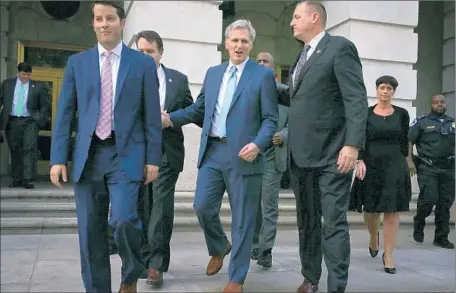  ?? Alex Wong Getty Images ?? HOUSE MAJORITY LEADER Kevin McCarthy, center, leaves with wife Judy, right, and colleagues after his unexpected announceme­nt.