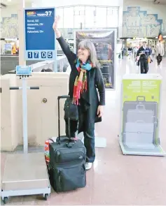  ??  ?? Hannon, who created Journeywom­an, an online resource for solo female travellers, waves goodbye to friends at the Montreal train station.