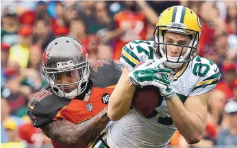  ?? BRIAN BLANCO/AP FILE ?? Packers wide receiver Jordy Nelson (87) makes a catch in front of Tampa Bay strong safety Bradley McDougald (30) during a game in 2014. Nelson missed last season because of a knee injury.