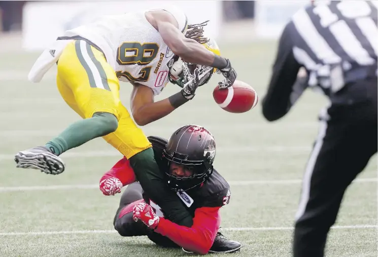  ?? DARREN MAKOWICHUK ?? Eskimos receiver Derel Walker loses control of the ball after being tackled by the Stampeders’ Tre Roberson during Monday’s Labour Day Classic in Calgary. Walker is among a number of players on both teams forced out of Saturday’s rematch at Commonweal­th Stadium with injuries.