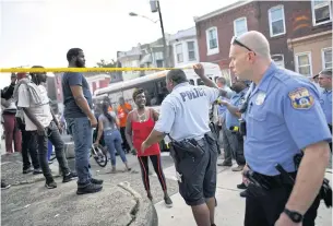  ?? AFP ?? Police officers direct people to move back near the scene of a shooting in Philadelph­ia, Pennsylvan­ia.