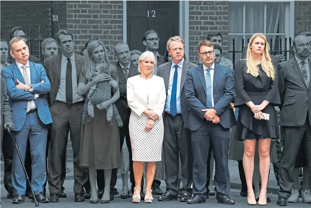  ?? ?? Joining his wife Carrie, aides and supporters line up behind Boris Johnson outside No 10 on July 7 as he announced his resignatio­n as Prime Minister. Several are reportedly being given peerages in his resignatio­n honours list: in colour from left to right, former minister of state Nigel Adams, ex-Culture Secretary Nadine Dorries, Scottish Secretary Alister Jack, former No 10 deputy chief of staff Ben Gascoigne and ex-Downing Street special adviser Charlotte Owen