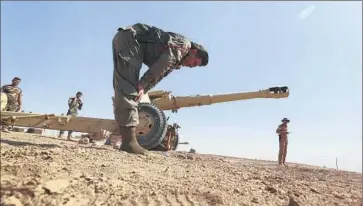  ?? Hadi Mizban
Associated Press ?? A KURDISH peshmerga fighter prays last week in a northern Iraqi village after Kurdish forces seized it from Islamic State militants. The Kurdish fighters have made steady progress against the militants in the region.