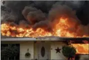  ?? NOAH BERGER — THE ASSOCIATED PRESS FILE ?? Flames consume a home as the Camp Fire tears through Paradise on Thursday.