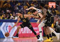  ?? C1 ?? The Warriors' Stephen Curry, left, and Andrew Wiggins, right, battle the Dallas Mavericks' Luka Doncic for a loose ball in the first quarter of Game 5of the Western Conference finals on Thursday.
In Sports: Return to NBA Finals a `surreal feeling' for Thompson.