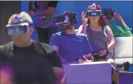  ?? Gina Ferazzi Los Angeles Times ?? ATTENDEES try out the Samsung Gear VR, powered by Oculus, during the Oculus Connect seminar at the Lowes Hollywood Hotel in Los Angeles in 2015.