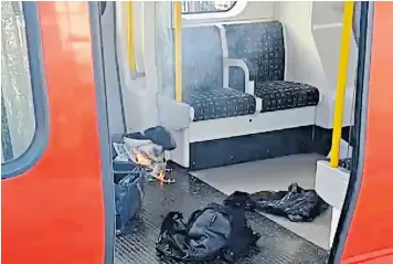  ??  ?? The device, left, appeared not to have fully detonated but was instead left burning and smoking near a carriage exit. Right, a woman with her head bandaged is assisted by a police officer at Parsons Green station. Several victims were reported to have...