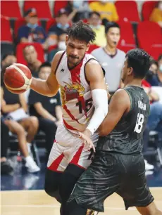  ?? (PBA Media Bureau photo) ?? San Miguel Beermen's June Mar Fajardo tries to ward off the defense of Terrafirma Dyip center Joseph Gabayni.