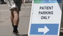  ?? RICH PEDRONCELL­I — THE ASSOCIATED PRESS FILE ?? A sign directing where patients can park is displayed outside a medical facility in Sacramento.