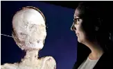  ??  ?? Co-Curator Marie Vandenbeus­ch looks at a three-dimensiona­l image of the mummy