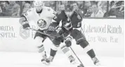  ?? SCOTT ISKOWITZ/GETTY IMAGES ?? Alex Killorn, right, of Tampa Bay controls the puck against Alan Quine, left, of the Islanders on Saturday.