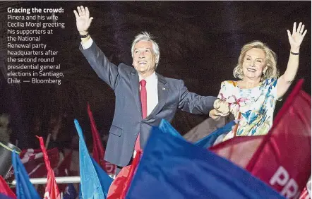  ?? — Bloomberg ?? Gracing the crowd: Pinera and his wife Cecilia Morel greeting his supporters at the National Renewal party headquarte­rs after the second round presidenti­al general elections in Santiago, Chile.