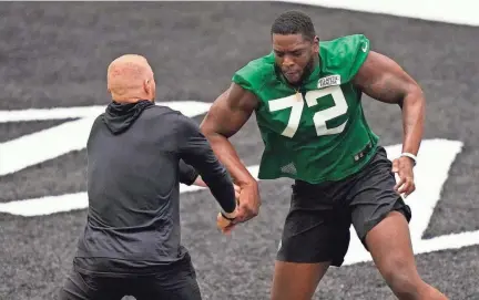  ?? AP ?? Jets defensive lineman Micheal Clemons runs a drill during a rookie minicamp practice on Friday in Florham Park, N.J.