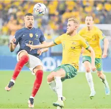  ?? — AFP photo ?? France’s Kylian Mbappe (le ) fights for the ball with Australia’s Nathaniel Atkinson.