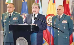  ?? AFP ?? Colombian Minister of National Defence Carlos Holmes Trujillo Garcia (centre) said the military will step up an offensive against drug traffickin­g gangs responsibl­e for clearing thousands of hectares of protected national parks for coca plantation­s.