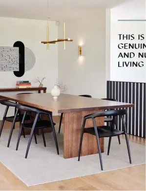  ?? ?? LEFT The family eats most of their meals in the kitchen (opposite), meaning this adjacent dining area is used for more formal occasions and as an office space if required. On a rug made from some of the Kindu carpet from Artisan left over from the kids’ bedrooms, a dining table crafted from solid Tasmanian blackwood by Hamilton company Kor is teamed with Maki chairs by MCM House. The pendant and wall light are from Nightworks’ Petrine series, and above the heirloom sideboard is Myriorama: OAAEAO:5 by Julia Morison, one of several artworks in the home curated by ARC Fine Art Services. OPPOSITE Skylights in the kitchen drench it in natural light from above. Apart from the integrated fridge by Fisher & Paykel with Beam handles by Powersurge, the appliances here are by Miele. The mouthblown Parison pendant lights are by Cheshire Architects for Resident and the Kashmir chairs are by Simon James for Resident.