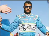  ?? Steve Helber / Associated Press ?? Bubba Wallace greets fans during a NASCAR Cup Series race at Martinsvil­le Speedway in Martinsvil­le, Va., in October.