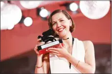  ??  ?? Maggie Gyllenhaal holds the Best Screenplay award for ‘The Lost Daughter.’ (AP)