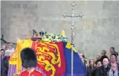  ?? —AFP ?? The coffin of Queen Elizabeth II lies in state as members of the public file past in Westminste­r Hall, London, on Friday