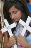  ?? Delcia Lopez/ The Monitor via AP ?? Dayra, 10, an immigrant from Mexico, bows her head after describing her experience at a U. S Border Patrol Processing Center, during a protest Friday outside the center in McAllen, Texas.