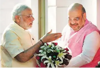  ?? PTI ?? Celebratio­n time Prime Minister Narendra Modi is greeted by BJP President Amit Shah on his arrival at the party headquarte­rs to meet the party’s central office bearers on the occasion of the first anniversar­y of his government, in New Delhi, yesterday.