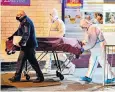  ?? ?? Police remove the body from the post office in Carlow, south-east Ireland