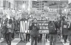  ?? JOSE LUIS MAGANA, AP ?? Demonstrat­ors march in downtown Washington Sunday before President- elect Donald Trump’s inaugurati­on Friday.