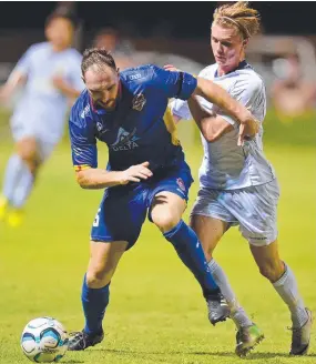  ?? MY BALL: NQ’s Ben Richardson fends off a GC player. Picture: SCOTT RADFORD- CHISHOLM ??