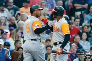  ?? Associated Press ?? n Baltimore Orioles' Jonathan Schoop (6) celebrates his solo home run with Adam Jones during the eighth inning of a baseball game against the Boston Red Sox Saturday in Boston.