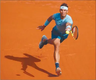  ?? The Associated Press ?? Spain’s Rafael Nadal returns a shot against Argentina’s Juan Martin del Potro during their semifinal match at the French Open in Paris, France, on Friday. Nadal won 6-4, 6-1, 6-2.