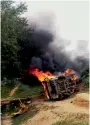 ?? PTI ?? Villagers set ablaze a van after a train hit a school van at an unmanned railway crossing in Bhadohi. —