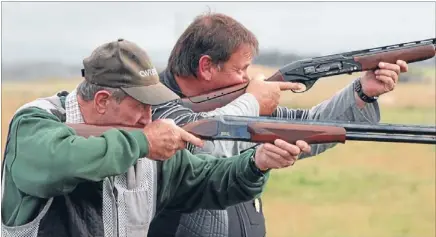  ?? Photo: ROBYN EDIE/FAIRFAX NZ 626130048 ?? Shot, son: Otautau father and son Reg and Peter Drake get prepared for this weekend’s New Zealand National Sporting Clay championsh­ips at Northburn Station, near Cromwell.